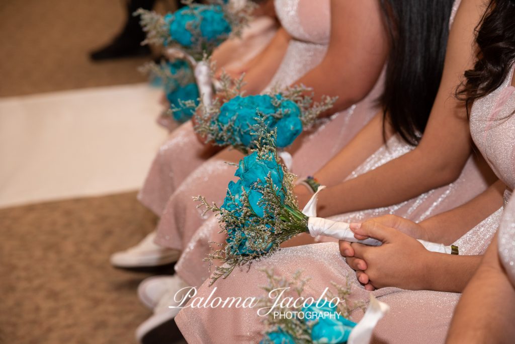 Quinceanera's Damas holding bouquets during Ceremony by Paloma Jacobo Photography
