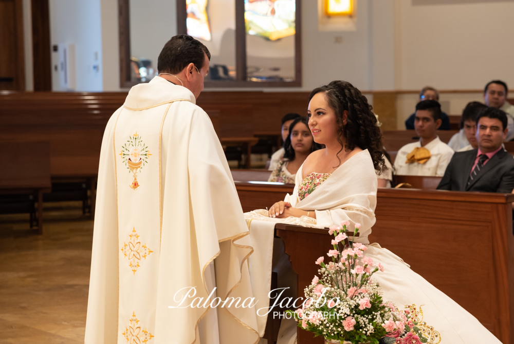 Quinceanera kneeling at church by Paloma Jacobo Photography