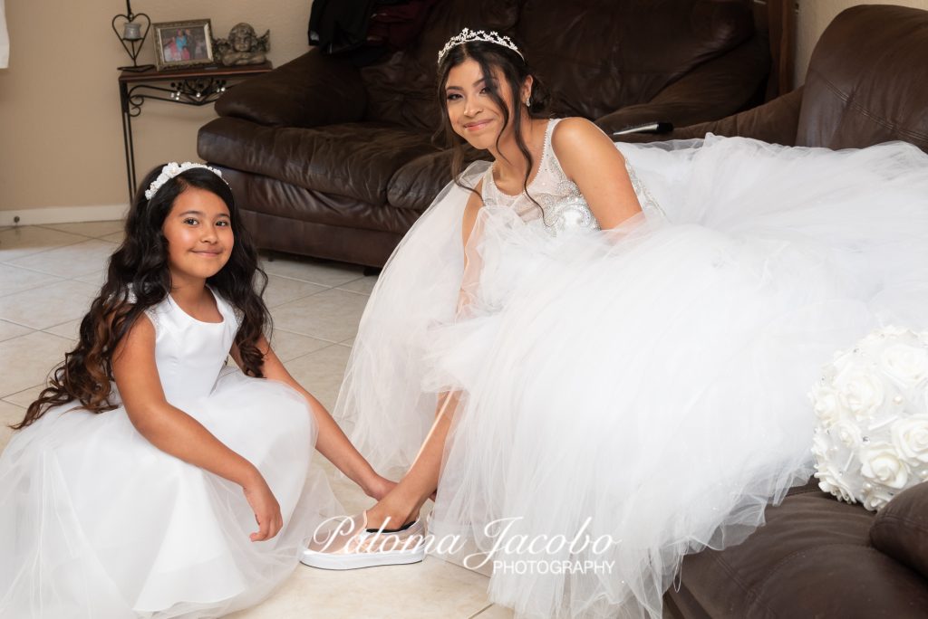 Quinceanera putting shoes on. San Diego Quinceanera Photography by Paloma Jacobo