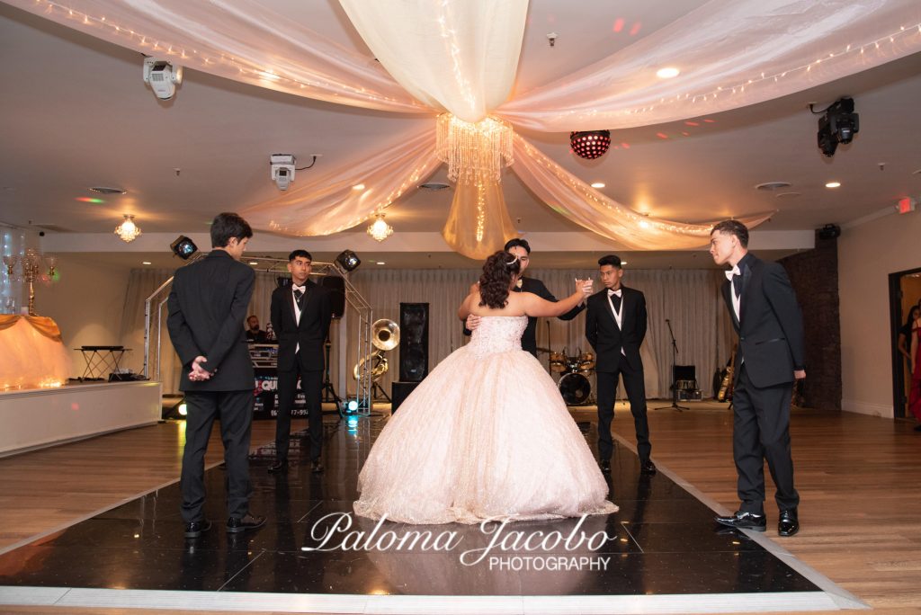 Quinceanera dancing the Waltz with her Chambelanes at Boulevard Hall by Paloma Jacobo Photography