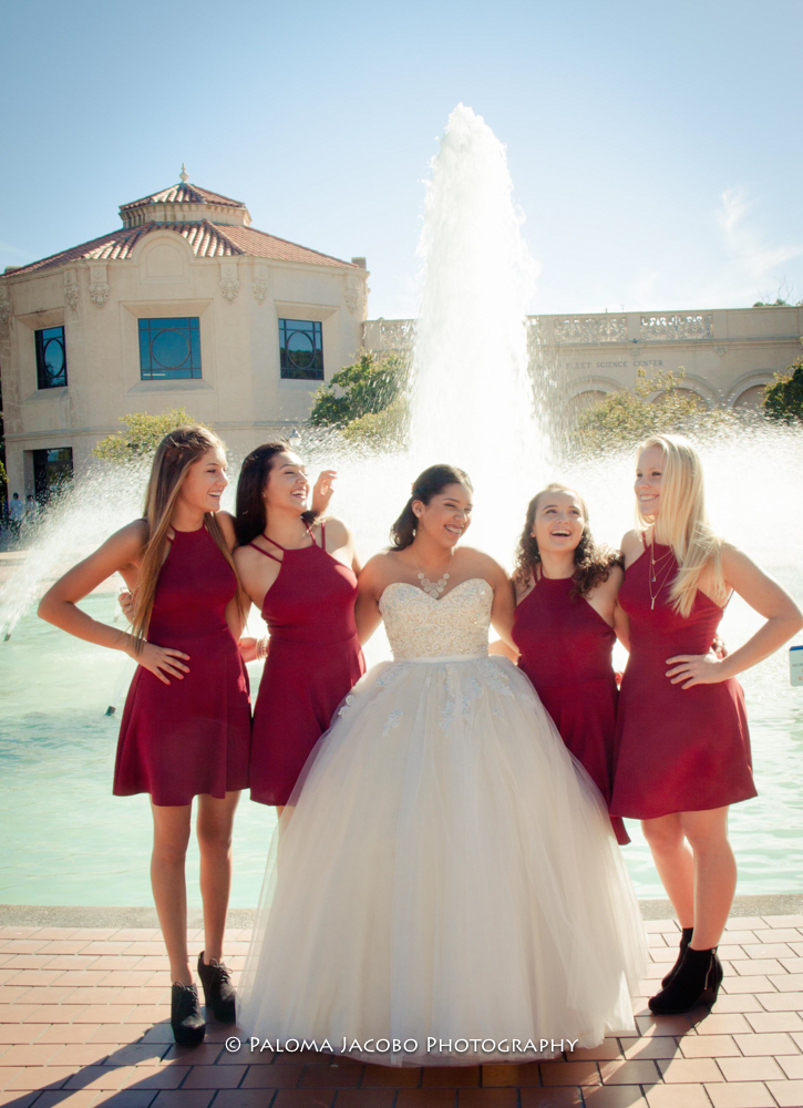 Quinceanera hugging her damas and having fun at the photo shoot
