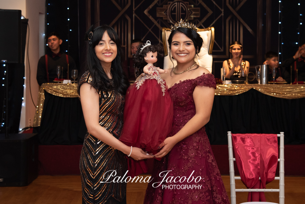 Quinceanera receiving her last doll at Quinceanera party