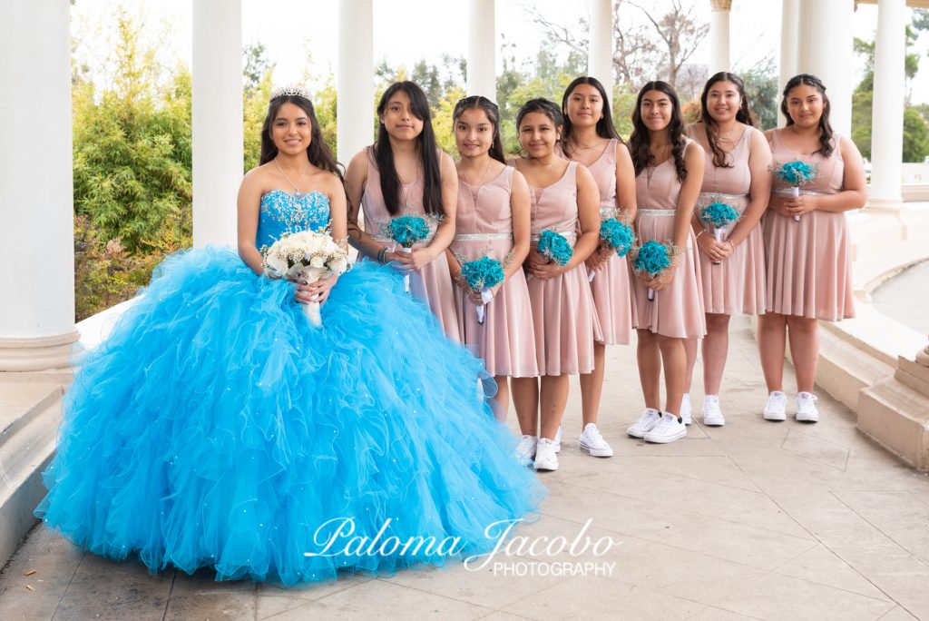 Quinceanera posing with her damas at the organ pavilion I nSan Diego