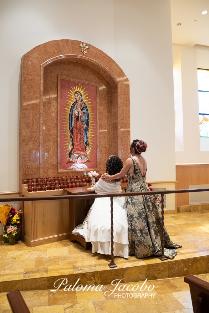 Quinceanera offering flowers to the virgin by Paloma Jacobo Photography