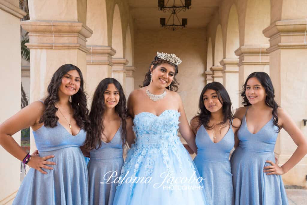 Quinceanera and her Damas smiling at the camera

