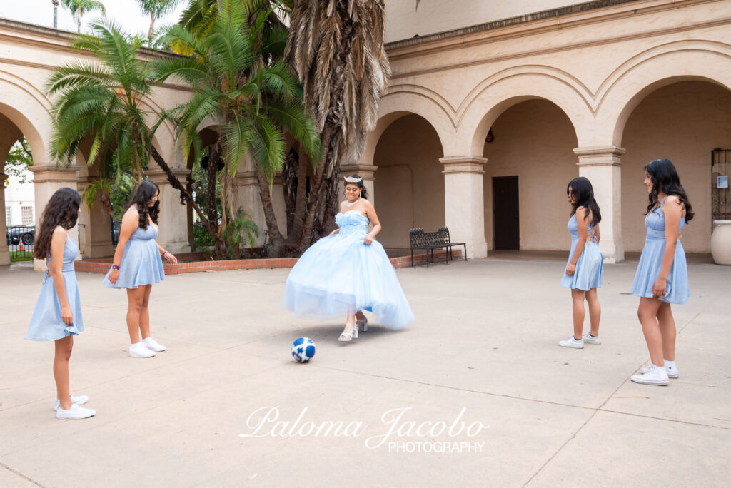 Quinceanera picture playing soccer with her damas in Balboa park