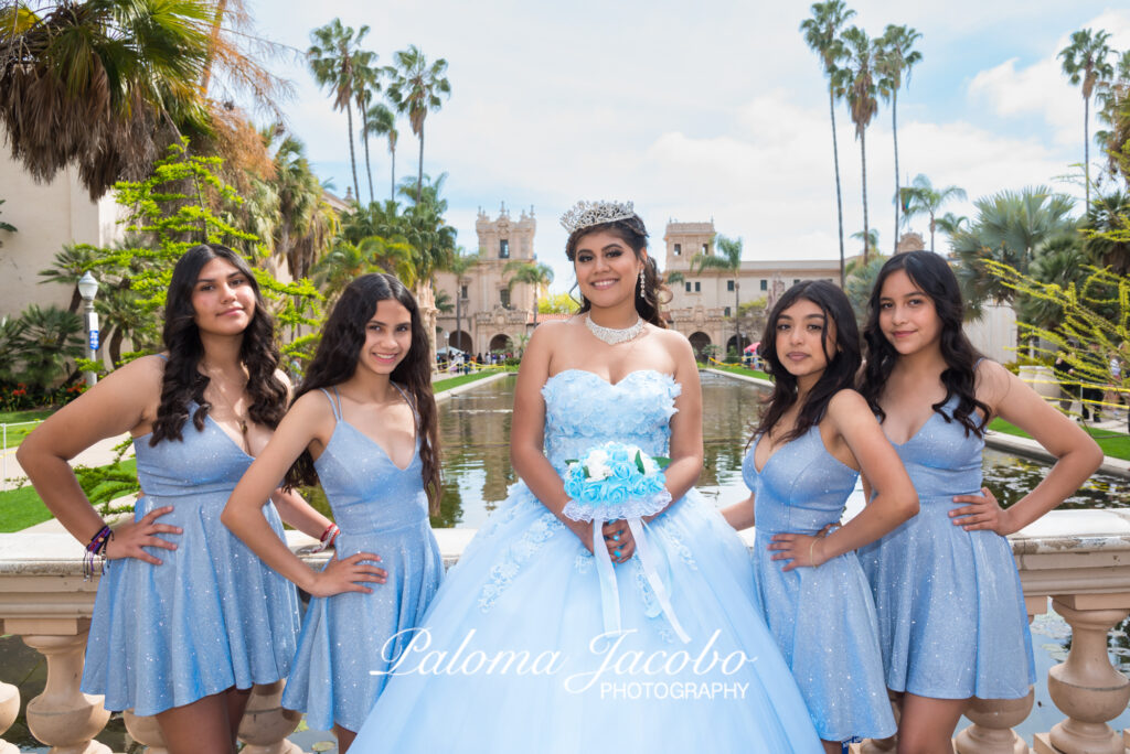 Quinceanera posing with her Damas by the Lily pond in Balboa Park.