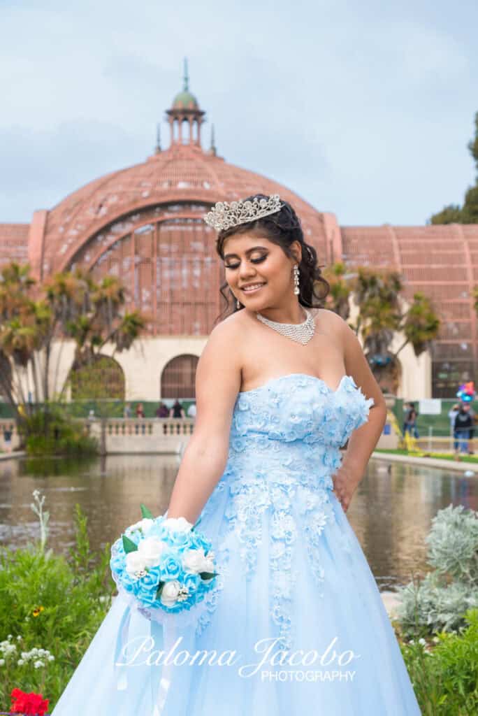 Quinceanera looking down at her bouquet