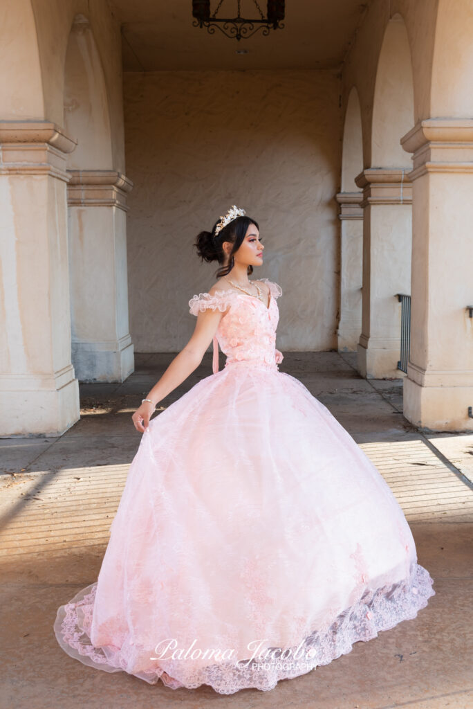 Quinceanera picture with arches on the background at Balboa Park