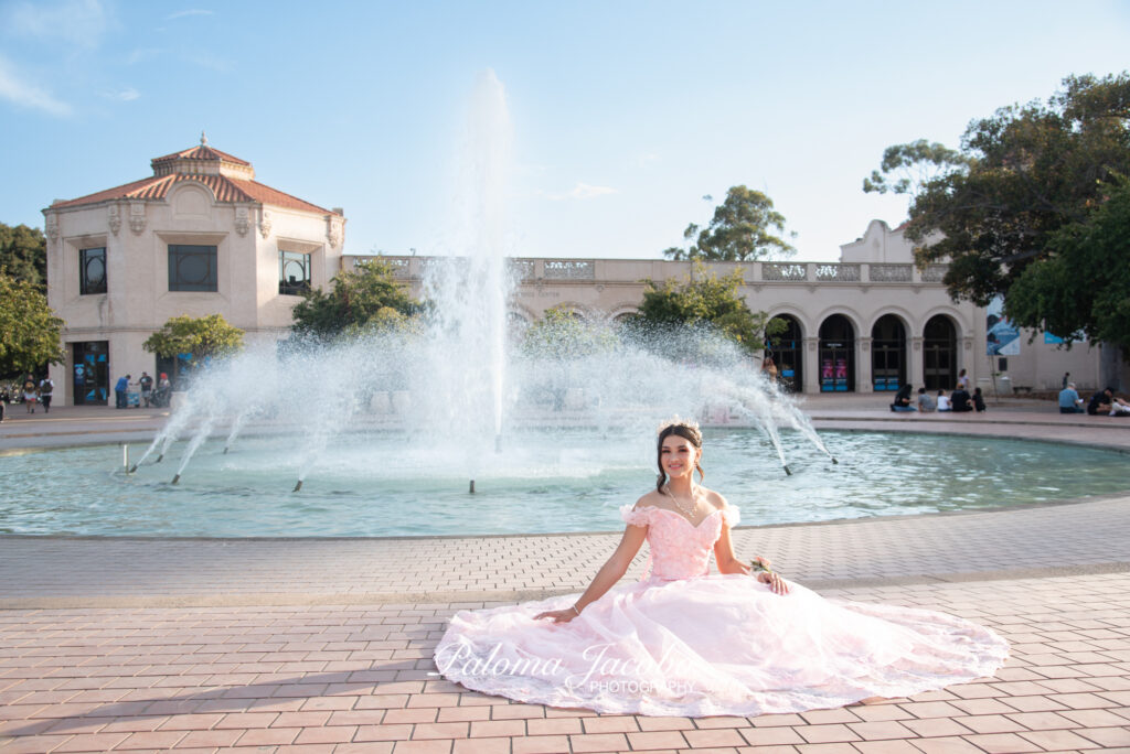 Quinceanera sitting down by the Bea Evenson fountain at Balboa Park