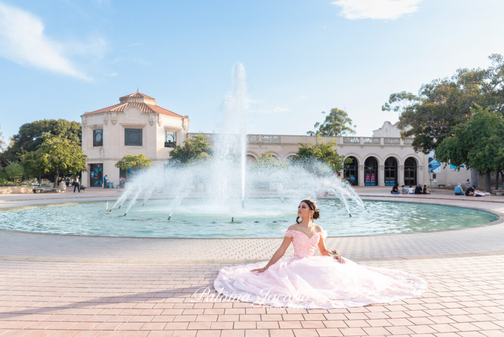 Portrait of a Quinceanera sitting down by the Bea Evenson fountain at Balboa park