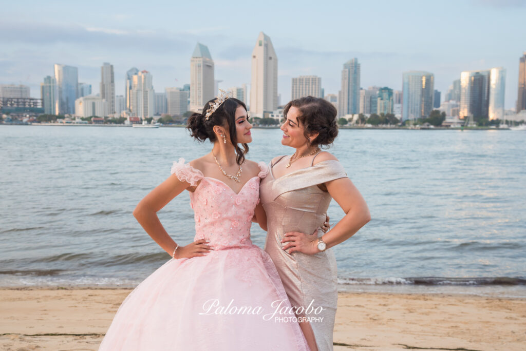 Quinceanera and her mom having a nice moment at the beach during the photo shoot