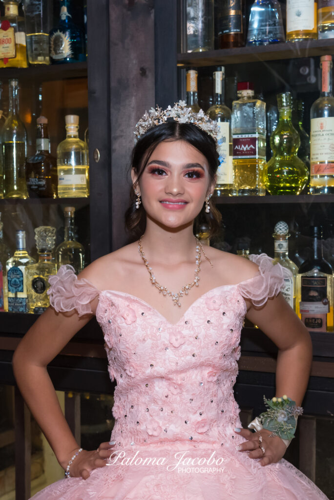 Quinceanera wearing an elegant pink dress at her nice dinner