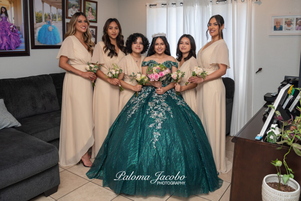 Quinceanera posing with her Damas in the living room